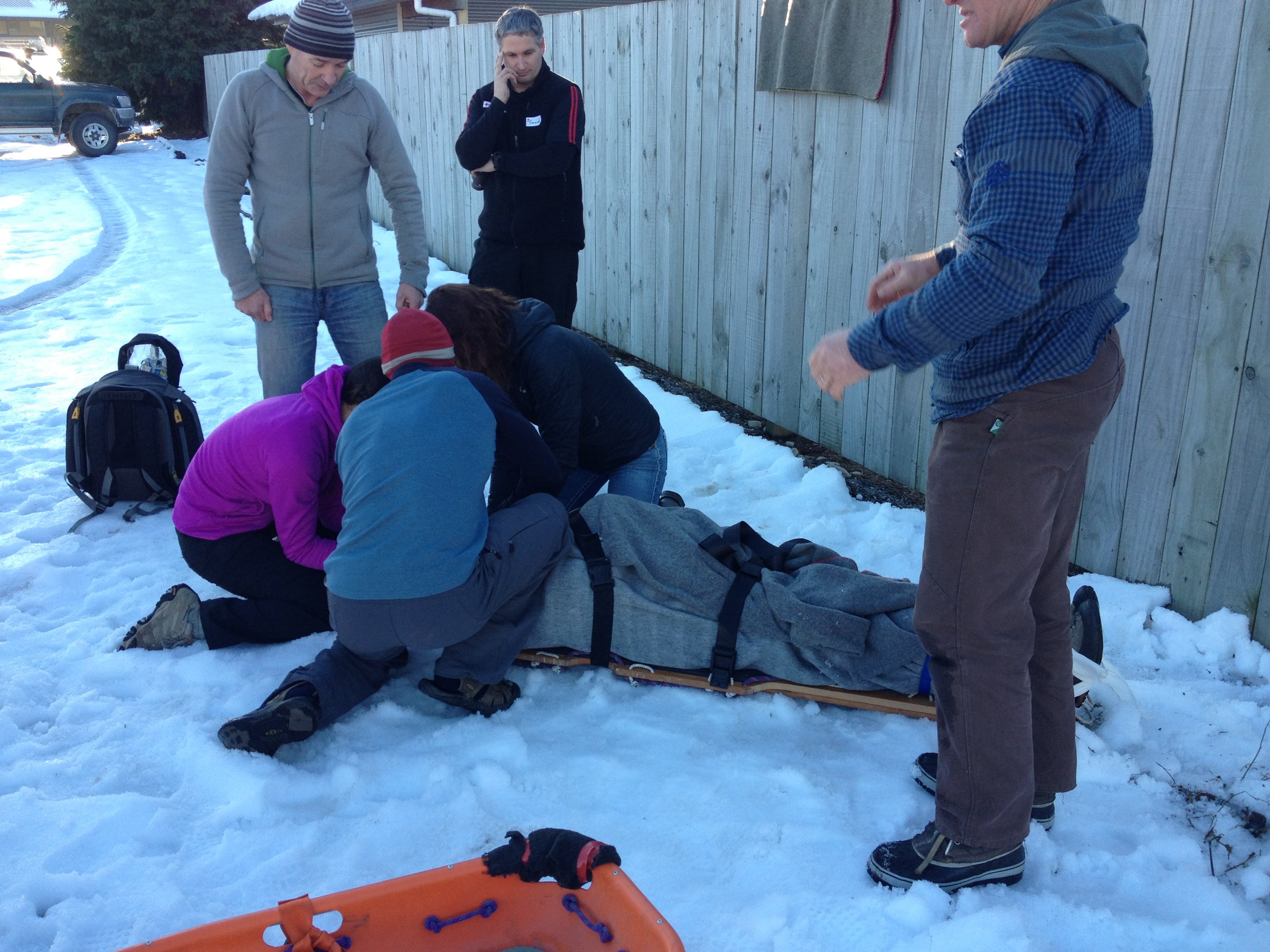 Deepka Dassanayake demonstrating first aid in snow with students watching